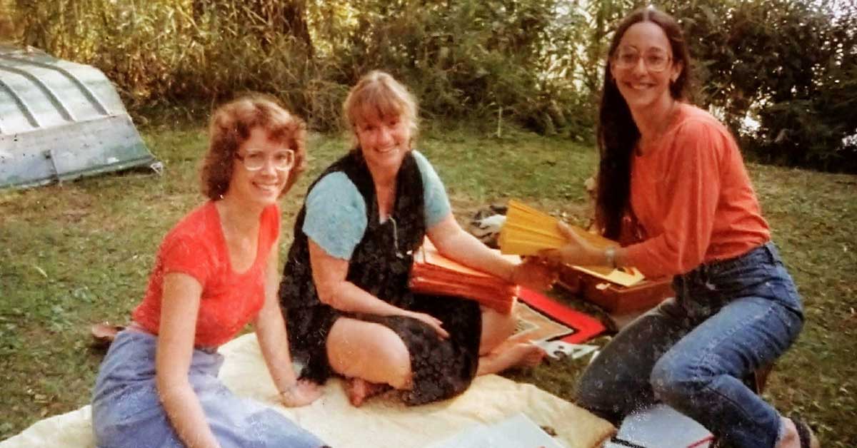 Photo: Suzanne Gilbert, Jahanara Romney, and Girija Brilliant prepare for the 1982 Board meeting outside the first Seva office.